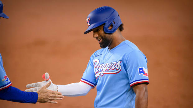 Jun 5, 2022; Arlington, Texas, USA; Texas Rangers third baseman Ezequiel Duran (70) celebrates getting his first career MLB hit during the second inning against the Seattle Mariners at Globe Life Field. Mandatory Credit: Jerome Miron-USA TODAY Sports